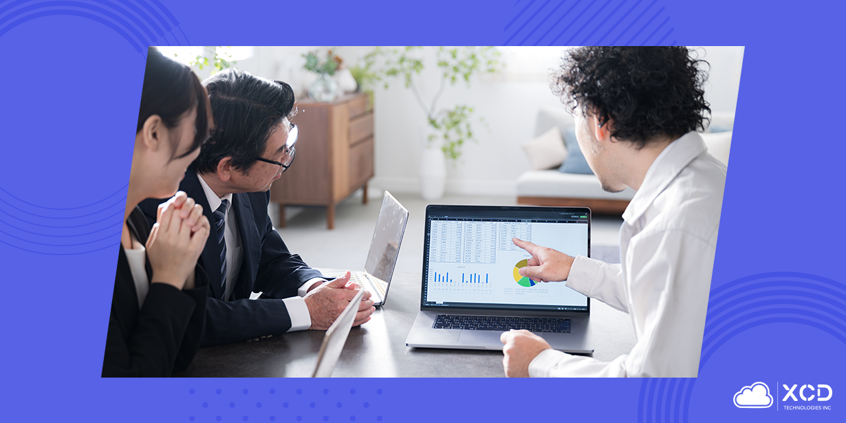 Business professionals reviewing sustainability data on a laptop for green event management, with charts and graphs displayed on screen.