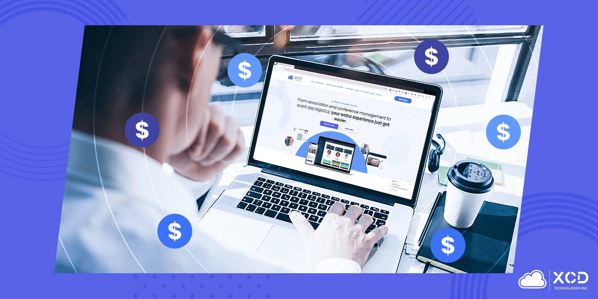 A man working on a laptop displaying the X-CD event management software homepage, doing pricing comparison research for event management platforms.