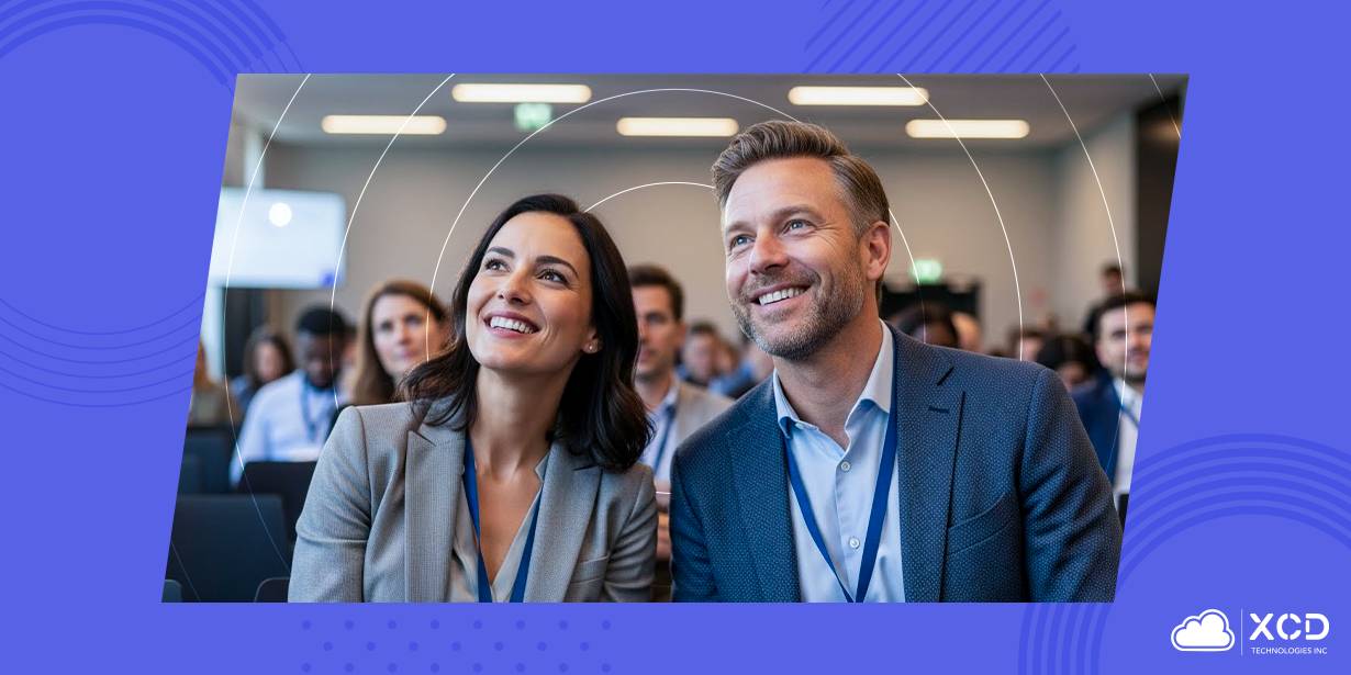 A man and a woman smiling and talking at an academic conference during a professional presentation